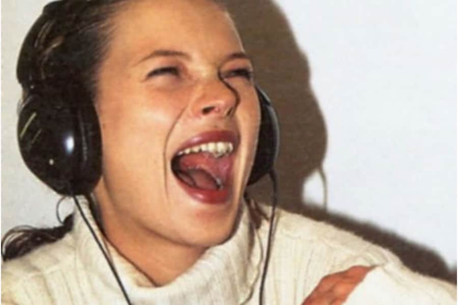 Kate Moss listening to music with headphones