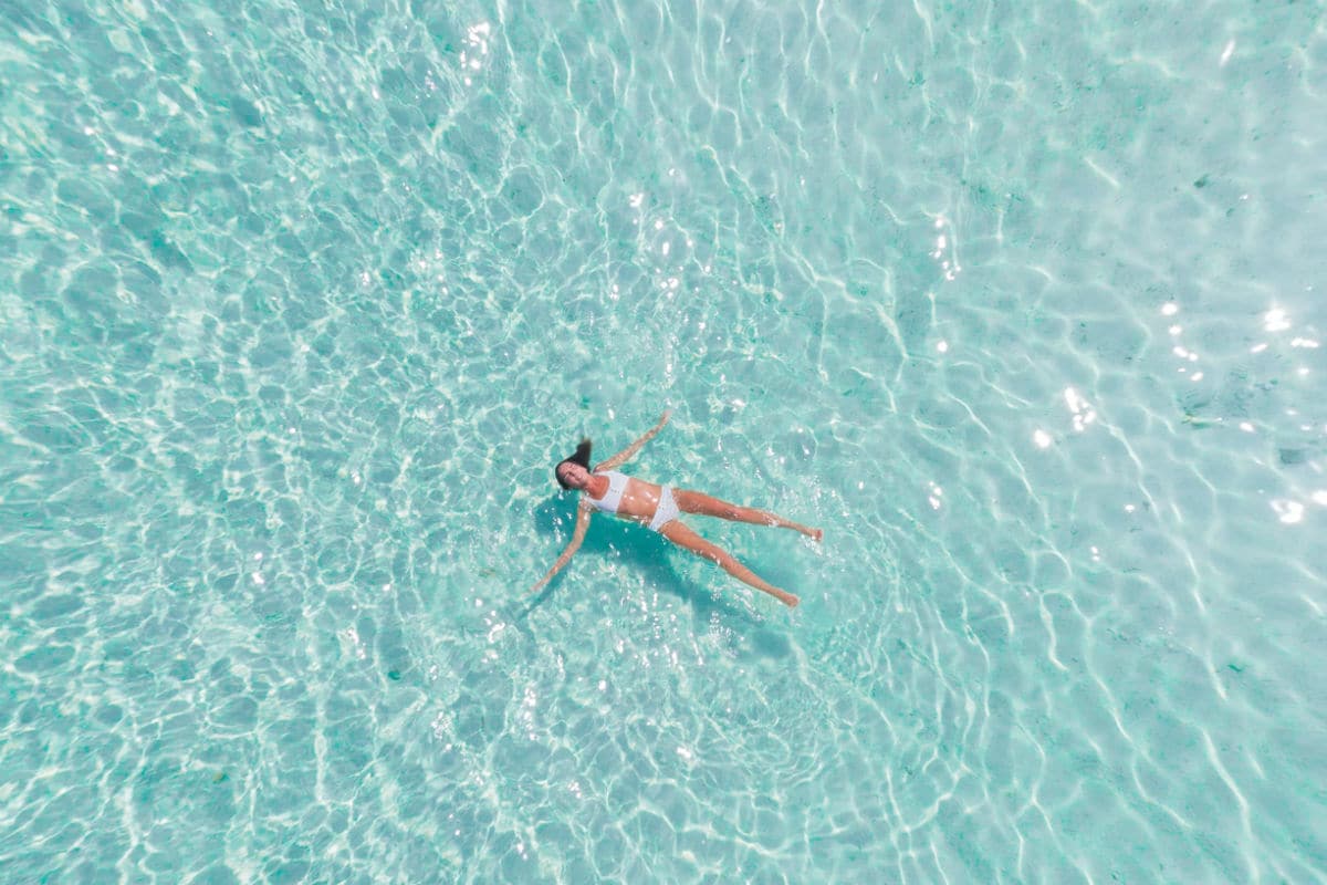 Woman swimming in blue water