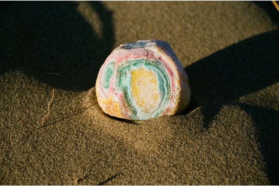 a photo of a colourful stone on the sand from Lina Scheynius photo-essay for Tabayer jewelry Tabayer jewellery