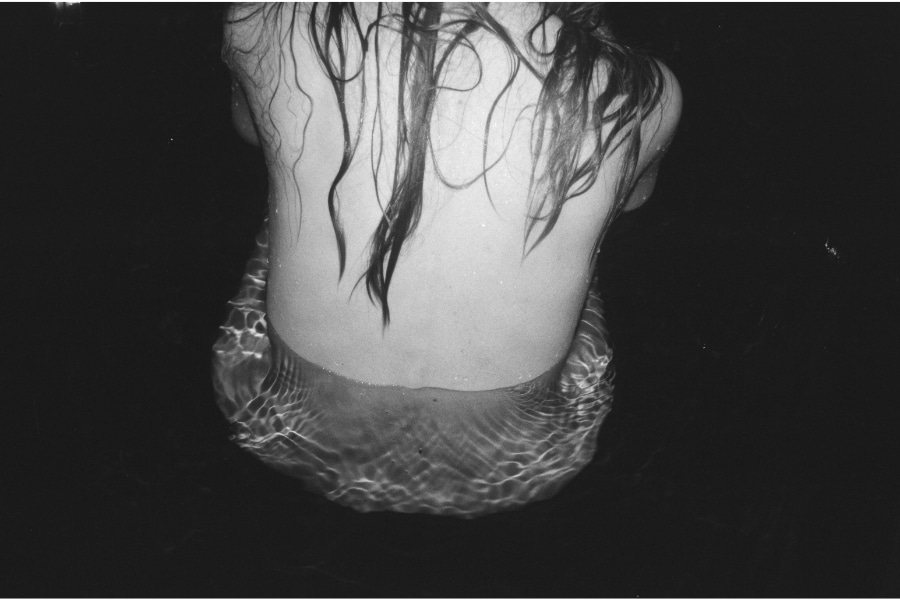 a black and white photo of a woman back with wet hair from Lina Scheynius’ photo-essay for Tabayer jewelry Tabayer jewellery